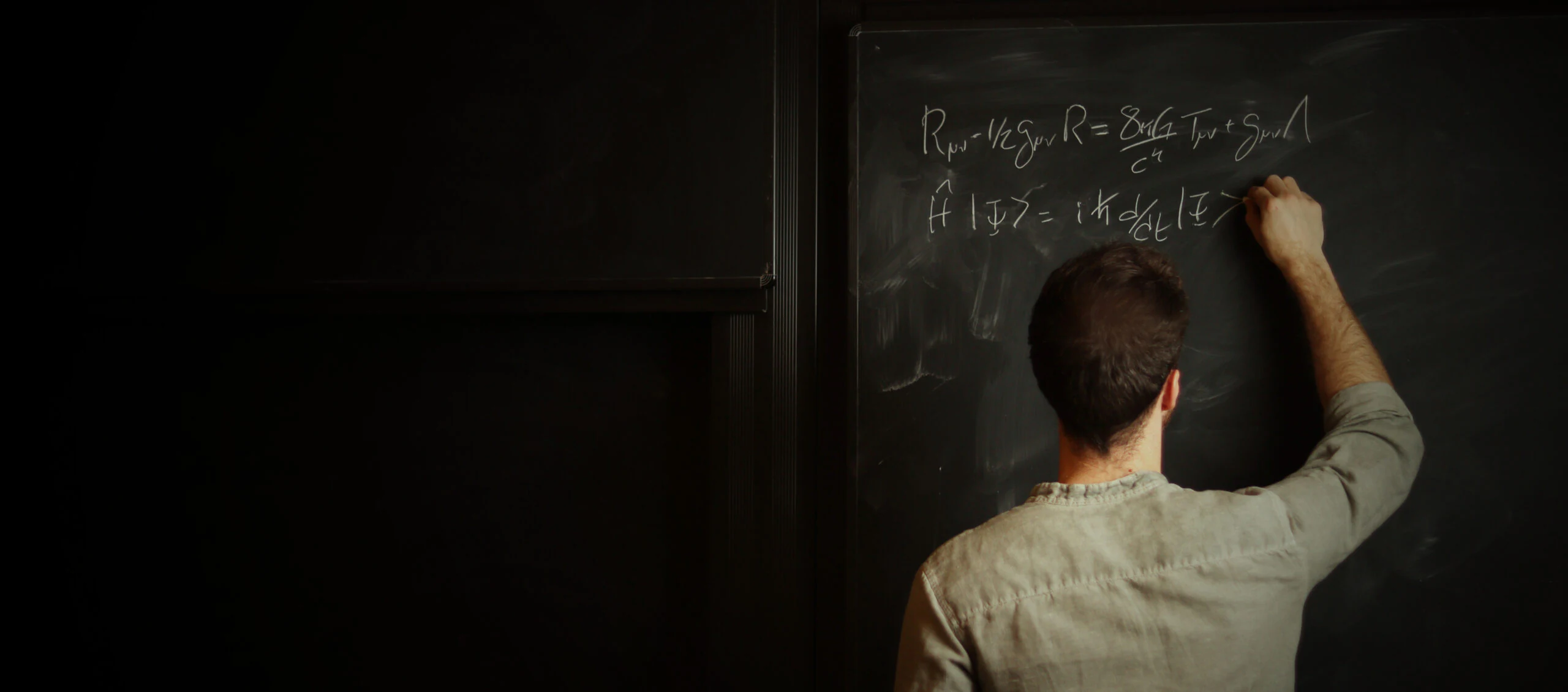Equations written across a blackboard